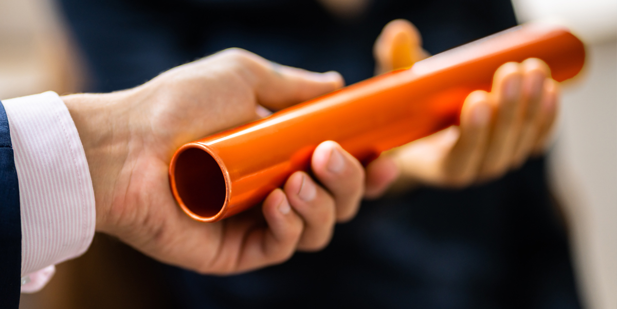 Business hands passing an orange baton