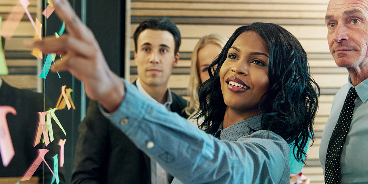 African American woman leading a team in a strategy session